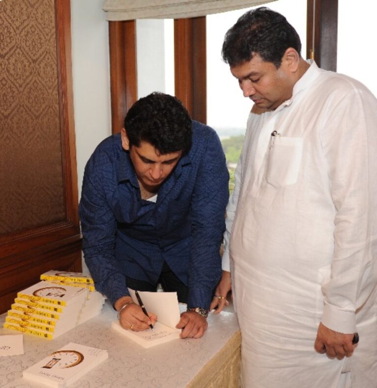 Sundeep Bhutoria with guest author Sanjay Chopra signing off a copy of his book at the Author's Afternoon session in Kolkata