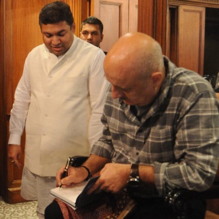 Sundeep Bhutoria with guest author Anupam Kher signing his book at a session of Author's Afternoon at The Taj Bengal, Kolkata