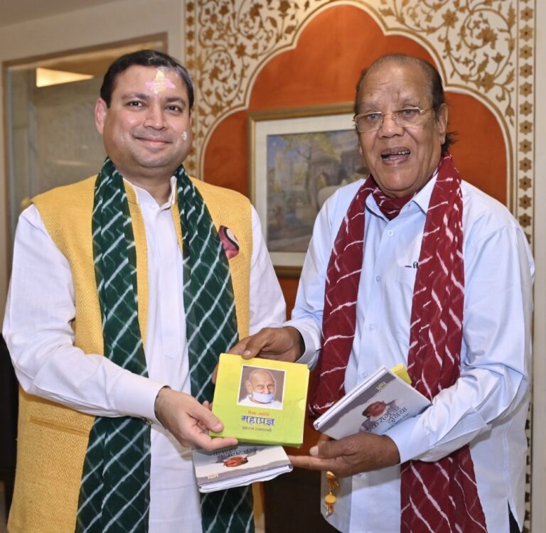 Ikraam Rajasthani presenting his book on Jain Acharya Mahapragya to Sundeep Bhutoria