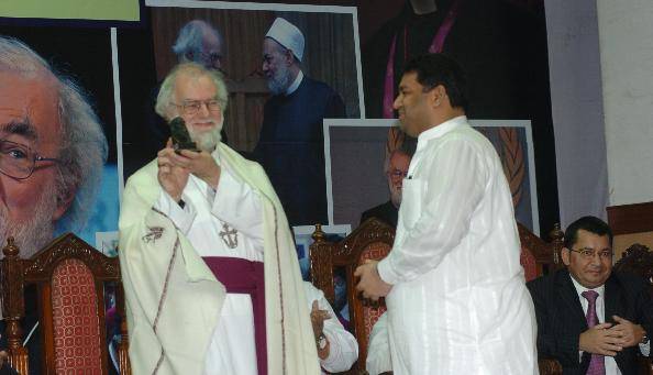 Sundeep Bhutoria presenting to Archbishop of Centerbury, Rev Rowan Williams, a small idol of Rabindranath Tagore, at the St Paul's Cathedral in Kolkata